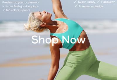 Green leggings and sports bra model in yoga pose on beach